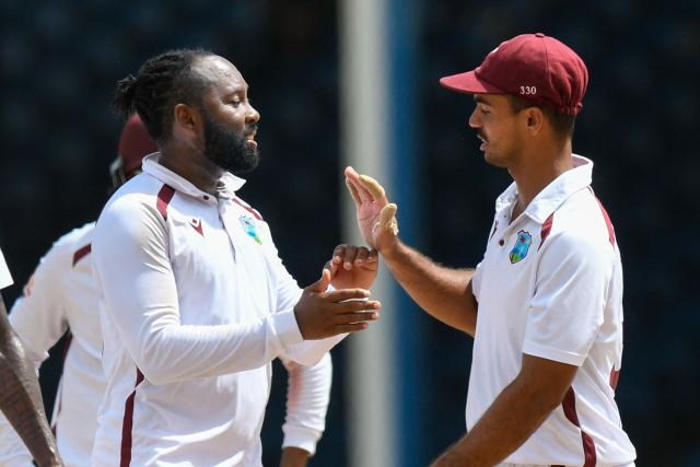 Jomel Warrican (L) and Tagenarine Chanderpaul (R) of West Indies celebrate the dismissal of Ali Usman of Pakistan during the third day of the second Test match between West Indies and Pakistan at Queen's Park Oval in Port of Spain, Trinidad and Tobago, on August 4, 2026. (Photo by Randy Brooks / AFP)