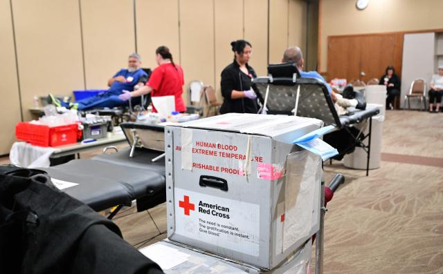 American Red Cross blood collection staff assist people donating blood during a blood drive amid an urgent need for donors at Providence St. Jude Medical Center in Fullerton, California, on August 4, 2026. The American Red Cross has declared its second-ever national blood supply crisis after donations fell to a four-year summer low, prompting a national emergency over declining blood supplies. (Photo by Frederic J. BROWN / AFP)