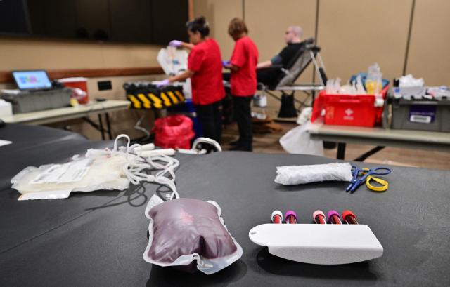 Vials of donated blood are seen beside a blood collection bag during a blood drive amid an urgent need for donors at Providence St. Jude Medical Center in Fullerton, California, on August 4, 2026. The American Red Cross has declared its second-ever national blood supply crisis after donations fell to a four-year summer low, prompting a national emergency over declining blood supplies. (Photo by Frederic J. BROWN / AFP)