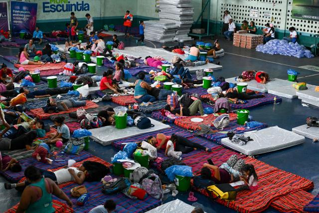 Evacuees rest at a shelter after fleeing their village following the eruption of Fuego volcano in Escuintla, Guatemala, on August 4, 2026. Guatemalan authorities issued the country's second-highest emergency alert level on August 4 after a major eruption of Central America's most active volcano, prompting the evacuation of nearby villages. (Photo by Johan ORDONEZ / AFP)