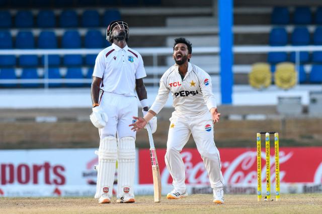 Bowler Ali Usman (R) of Pakistan celebrates after he caught and bowled batter Roston Chase (unseen) of West Indies as non-striking batter Justin Greaves looks on during the third day of the second Test match between West Indies and Pakistan at Queen's Park Oval in Port of Spain, Trinidad and Tobago, on August 4, 2026. (Photo by Randy Brooks / AFP)