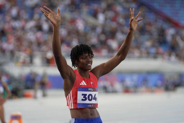 Dominican Republic's Marileidy Paulino waves before competing in the women's 400m semifinal, heat 1, during the XXV Central American and Caribbean Games at the Felix Sanchez Olympic Stadium in Santo Domingo on August 3, 2026. (Photo by Francesco SPOTORNO / AFP)