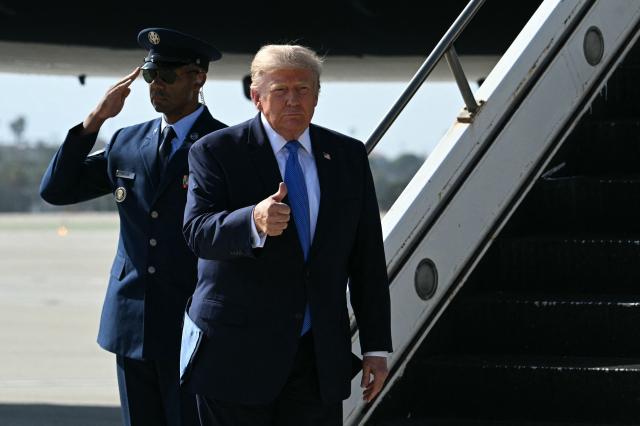 US President Donald Trump gives a thumbs up after stepping off Air Force One upon arrival at Los Angeles International Airport in Los Angeles on August 4, 2026. US President Donald Trump will stop at his Trump National Golf Club Los Angeles before departing for Las Vegas, where he is expected to deliver remarks on August 5 at Red Rock Casino Resort & Spa in Summerlin, Nevada, promoting the administration's tax-cut policies, including the "no tax on tips" measure. (Photo by Jim WATSON / AFP)