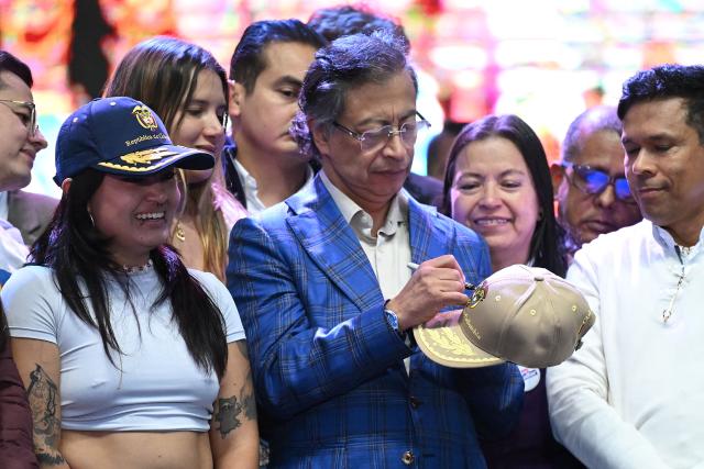 Colombian President Gustavo Petro signs a cap during the Festival for the Defense of Public Higher Education in Soacha, near Bogota on August 4, 2026. (Photo by Raul ARBOLEDA / AFP)