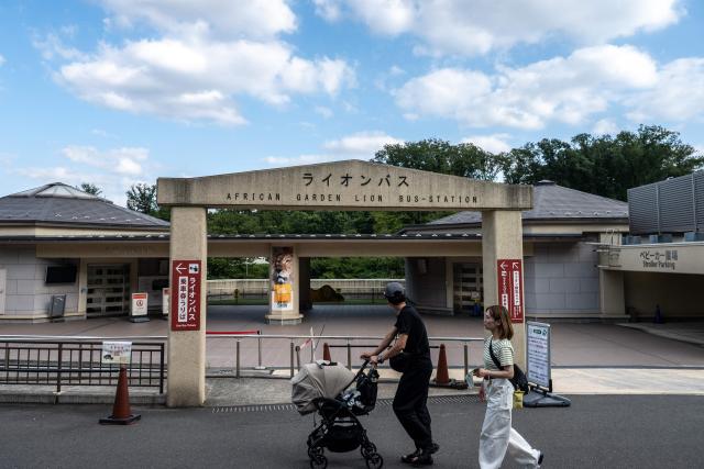 Visitors walk past the closed lion bus entrance of the lion enclosure area at Tama Zoological Park in Hino city of Tokyo Metropolis on August 4, 2026. Three lions at a Tokyo zoo have died from suspected heatstroke and others are under treatment, a spokeswoman said on Tuesday, with the big cats struggling with high humidity. (Photo by Philip FONG / AFP)