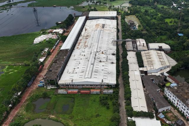 This aerial photograph taken on July 15, 2026 shows the closed Lithe Group garments factory at Baniachala in Bangladesh's Gazipur district. The closure of the Lithe Garments factory cost around 3,000 workers their jobs in a single night, underscoring strains in an industry that has powered Bangladesh's rise as the world's second-biggest apparel exporter after China. (Photo by Munir UZ ZAMAN / AFP) / TO GO WITH: Bangladesh-economy-textile, FOCUS by Sheikh Sabiha ALAM