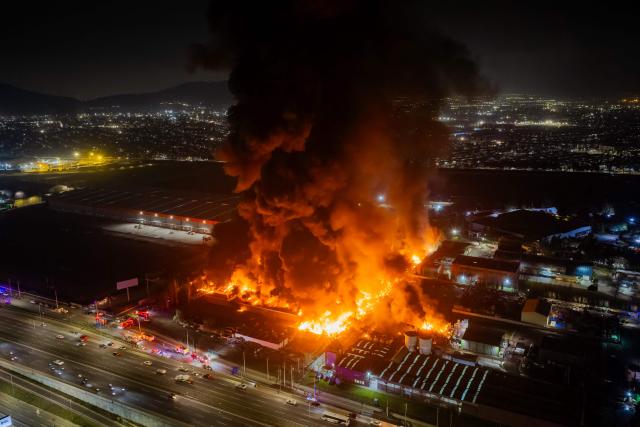 This aerial view shows a large fire at a chemical plant in the Quilicura commune of Santiago on August 4, 2026. (Photo by Javier TORRES / AFP)