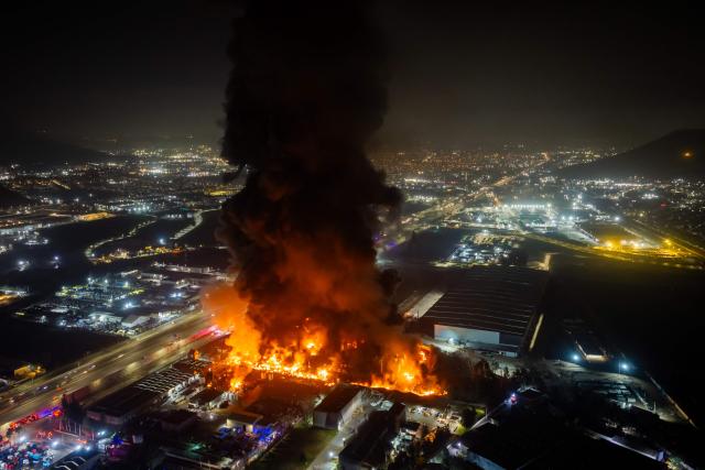 This aerial view shows a large fire at a chemical plant in the Quilicura commune of Santiago on August 4, 2026. (Photo by Javier TORRES / AFP)