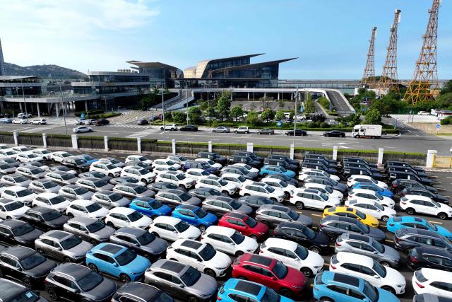 Chinese-made MG vehicles wait to be loaded onto a ship for export at a car yard at the Dongfang Port Company terminal of Lianyungang Port in Jiangsu province, eastern China on August 4, 2026 (Photo by CN-STR / AFP) / China OUT