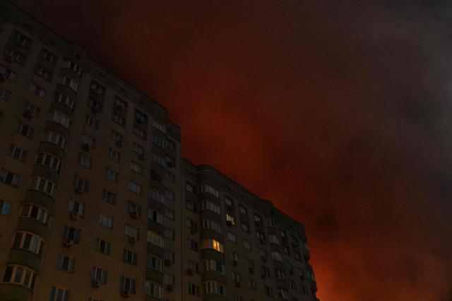 This photograph shows smoke rising from a warehouse destroyed during massive Russian ballistic missile and drone strikes next to a residential building on the outskirts of Kyiv early on August 5, 2026, amid the Russian invasion of Ukraine. Russian strikes on Ukraine's capital and surrounding region killed at least two people and wounded dozens more, authorities said on August 5, 2026, after fresh overnight missile and drone attacks. (Photo by Roman PILIPEY / AFP)