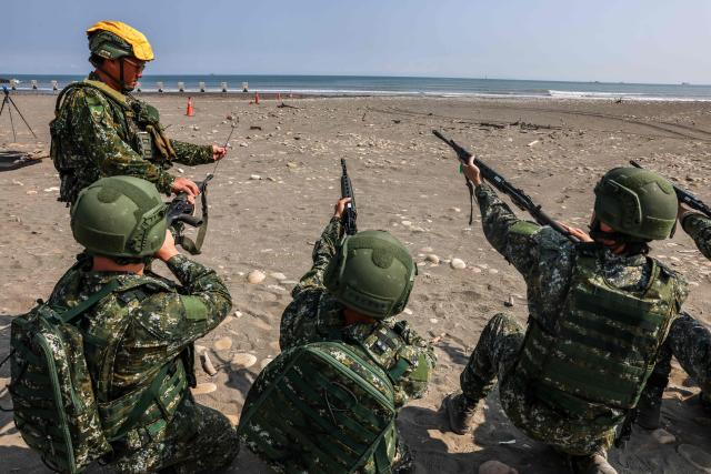 Taiwanese soldiers clean the barrels of their rifles after a live-fire exercise on Zhongfu Beach as part of annual Han Kuang military exercise in New Taipei City on August 5, 2026. (Photo by I-Hwa Cheng / AFP)