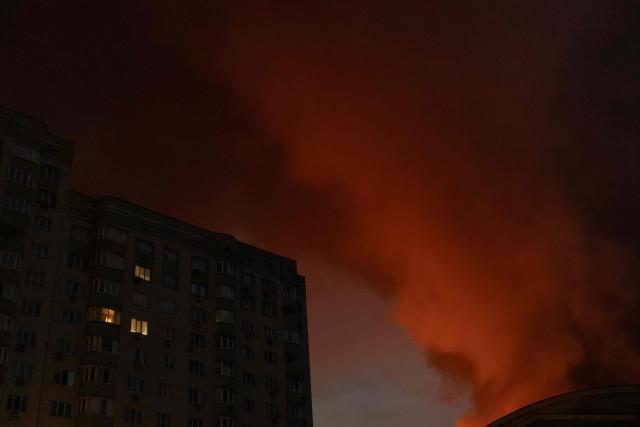 This photograph shows smoke rising from a warehouse destroyed during massive Russian ballistic missile and drone strikes next to a residential building on the outskirts of Kyiv early on August 5, 2026, amid the Russian invasion of Ukraine. Russian strikes on Ukraine's capital and surrounding region killed at least two people and wounded dozens more, authorities said on August 5, 2026, after fresh overnight missile and drone attacks. (Photo by Roman PILIPEY / AFP)