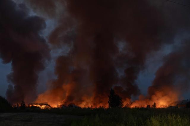 This photograph shows fire and smoke rising from a warehouse destroyed during massive Russian ballistic missile and drone strikes on the outskirts of Kyiv early on August 5, 2026, amid the Russian invasion of Ukraine. Russian strikes on Ukraine's capital and surrounding region killed at least two people and wounded dozens more, authorities said on August 5, 2026, after fresh overnight missile and drone attacks. (Photo by Roman PILIPEY / AFP)
