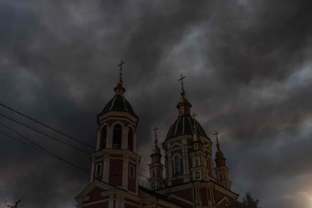 This photograph shows smoke rising over a church following massive Russian ballistic missile and drone strikes on the outskirts of Kyiv early on August 5, 2026, amid the Russian invasion of Ukraine. Russian strikes on Ukraine's capital and surrounding region killed at least two people and wounded dozens more, authorities said on August 5, 2026, after fresh overnight missile and drone attacks. (Photo by Roman PILIPEY / AFP)