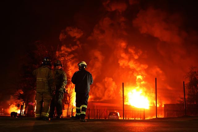 Firefighters battle a large fire at a chemical plant in the Quilicura commune of Santiago on August 4, 2026. (Photo by Javier TORRES / AFP)