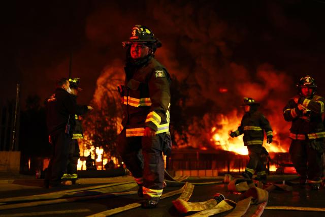 Firefighters battle a large fire at a chemical plant in the Quilicura commune of Santiago on August 4, 2026. (Photo by Javier TORRES / AFP)