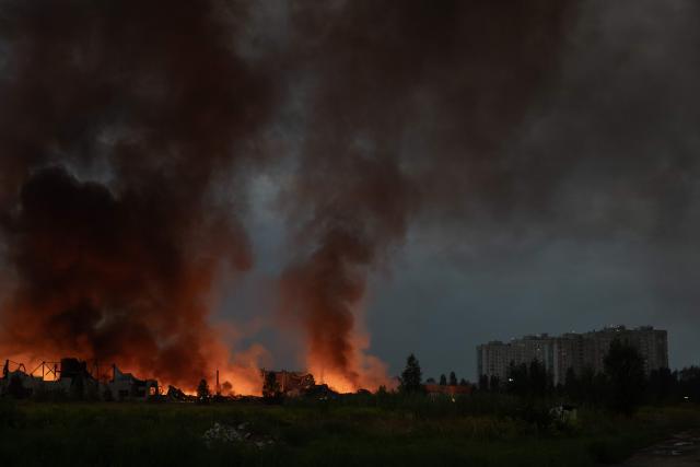 This photograph shows smoke rising from a warehouse destroyed during massive Russian ballistic missile and drone strikes on the outskirts of Kyiv early on August 5, 2026, amid the Russian invasion of Ukraine. Russian strikes on Ukraine's capital and surrounding region killed at least two people and wounded dozens more, authorities said on August 5, 2026, after fresh overnight missile and drone attacks. (Photo by Roman PILIPEY / AFP)