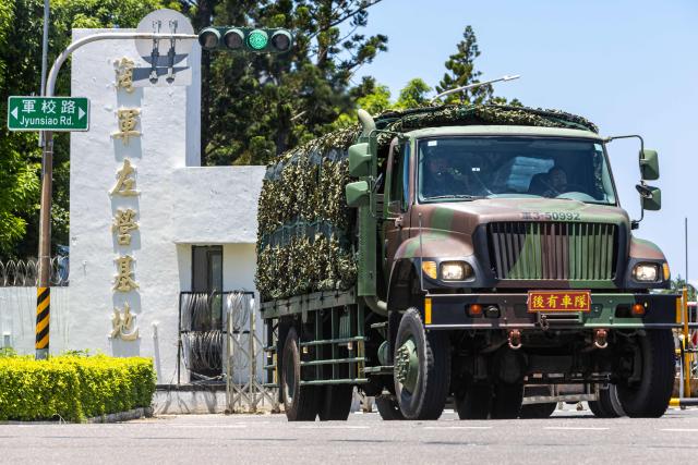 A military truck, covered with camouflage netting, departs from the Tsoying Naval Base on Jyunsiao Road on the opening day of the annual Han Kuang military exercise in Kaohsiung on August 5, 2026. (Photo by cheng-chia huang / AFP)