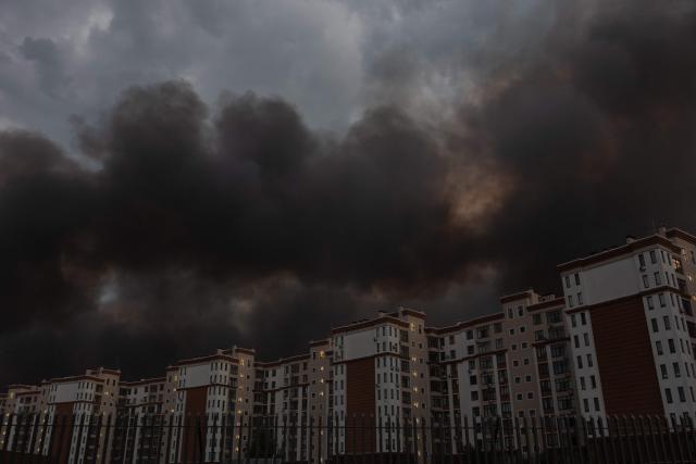 This photograph shows smoke rising over residential buildings following massive Russian ballistic missile and drone strikes on the outskirts of Kyiv early on August 5, 2026, amid the Russian invasion of Ukraine. Russian strikes on Ukraine's capital and surrounding region killed at least two people and wounded dozens more, authorities said on August 5, 2026, after fresh overnight missile and drone attacks. (Photo by Roman PILIPEY / AFP)