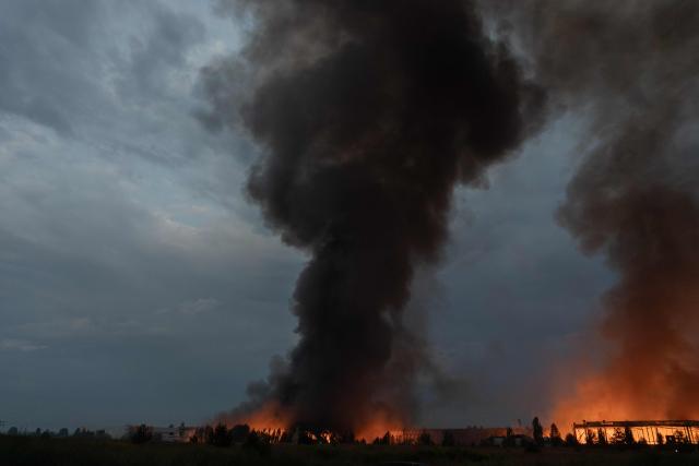 This photograph shows smoke rising from a warehouse destroyed during massive Russian ballistic missile and drone strikes on the outskirts of Kyiv early on August 5, 2026, amid the Russian invasion of Ukraine. Russian strikes on Ukraine's capital and surrounding region killed at least two people and wounded dozens more, authorities said on August 5, 2026, after fresh overnight missile and drone attacks. (Photo by Roman PILIPEY / AFP)