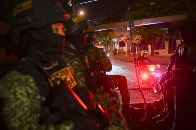 Colmbian policemen and soldiers patrol the Melendez neighborhood prior to the upcoming presidential inauguration of Colombia's president-elect Abelardo de la Espriella, in Cali, Colombia, on August 4, 2026. De la Espriella's inauguration will take place on August 7, 2026. (Photo by JOAQUIN SARMIENTO / AFP)