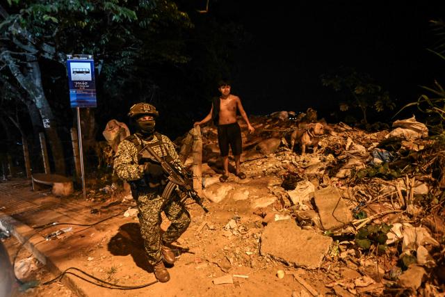 A Colombian soldier patrols the Melendez neighborhood prior to the upcoming presidential inauguration of Colombia's president-elect Abelardo de la Espriella, in Cali, Colombia, on August 4, 2026. De la Espriella's inauguration will take place on August 7, 2026. (Photo by JOAQUIN SARMIENTO / AFP)