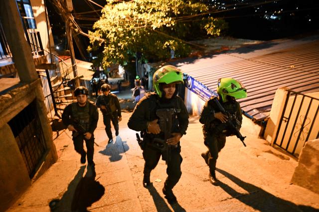Colombian policemen patrol the Melendez neighborhood prior to the upcoming presidential inauguration of Colombia's president-elect Abelardo de la Espriella, in Cali, Colombia, on August 4, 2026. De la Espriella's inauguration will take place on August 7, 2026. (Photo by JOAQUIN SARMIENTO / AFP)