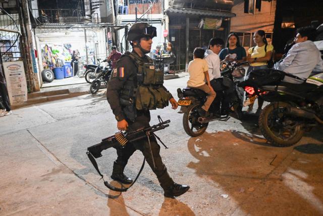 A Colombian policeman patrols in the Melendez neighborhood prior to the upcoming presidential inauguration of Colombia's president-elect Abelardo de la Espriella, in Cali, Colombia, on August 4, 2026. De la Espriella's inauguration will take place on August 7, 2026. (Photo by JOAQUIN SARMIENTO / AFP)