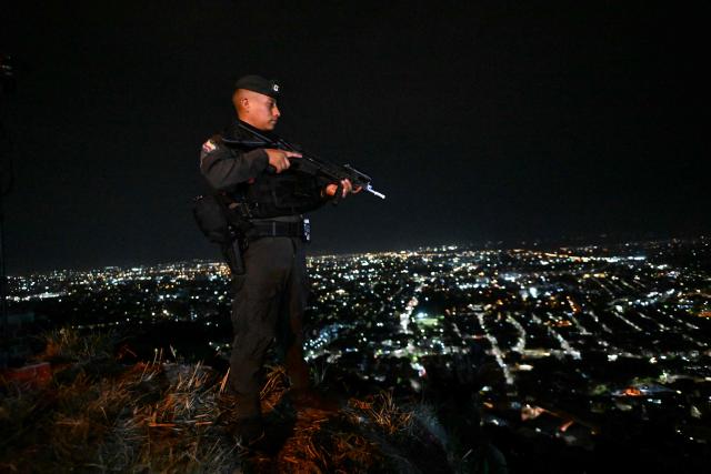 A Colombian policeman stands guard in the Melendez neighborhood prior to the upcoming presidential inauguration of Colombia's president-elect Abelardo de la Espriella, in Cali, Colombia, on August 4, 2026. De la Espriella's inauguration will take place on August 7, 2026. (Photo by JOAQUIN SARMIENTO / AFP)