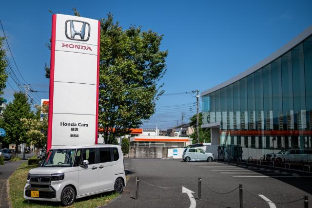 This photo shows signage at a car dealership for Japanese automaker Honda Motor along a street in Yokohama on August 5, 2026. (Photo by Philip FONG / AFP)
