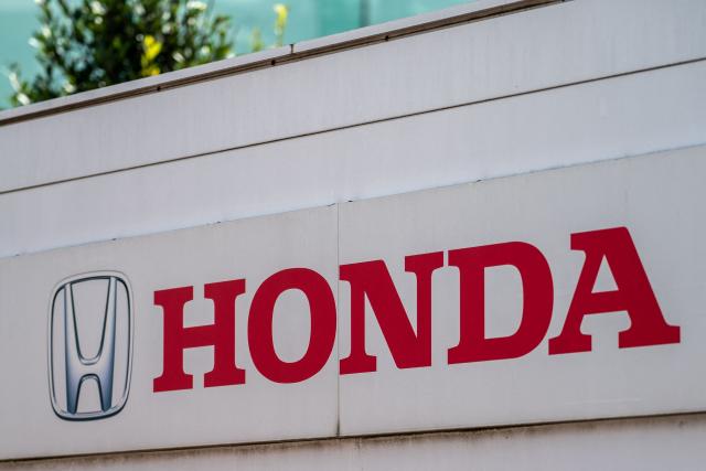 This photo shows signage at a car dealership for Japanese automaker Honda Motor along a street in Yokohama on August 5, 2026. (Photo by Philip FONG / AFP)