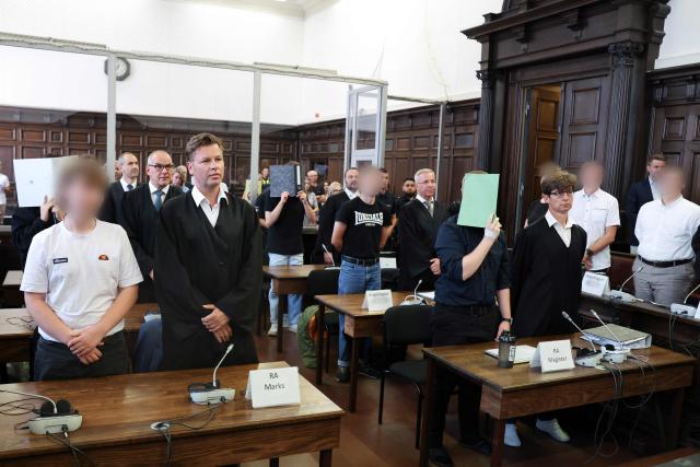 The defendants sit in the courtroom of the criminal justice building at the start of another day of hearings in the trial against the far-right terrorist group Last Wave of Defense, on August 5, 2026 in Hamburg. A German court gave prison sentences of up to five years on August 5, 2026 to seven alleged members or supporters of a German far-right militant group called the "Last Wave of Defence".
The men, all in their teens or early 20s, were convicted of crimes including membership in a terrorist organisation, attempted murder and arson for plotting attacks on refugees and left-wing activists. (Photo by Christian Charisius / POOL / AFP)