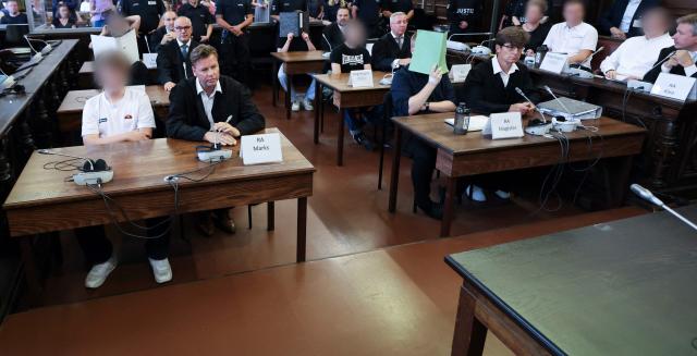 The defendants sit in the courtroom of the criminal justice building at the start of another day of hearings in the trial against the far-right terrorist group Last Wave of Defense, on August 5, 2026 in Hamburg. A German court gave prison sentences of up to five years on August 5, 2026 to seven alleged members or supporters of a German far-right militant group called the "Last Wave of Defence".
The men, all in their teens or early 20s, were convicted of crimes including membership in a terrorist organisation, attempted murder and arson for plotting attacks on refugees and left-wing activists. (Photo by Christian Charisius / POOL / AFP)