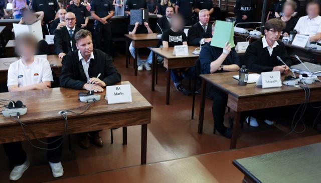 The defendants sit in the courtroom of the criminal justice building at the start of another day of hearings in the trial against the far-right terrorist group Last Wave of Defense, on August 5, 2026 in Hamburg. A German court gave prison sentences of up to five years on August 5, 2026 to seven alleged members or supporters of a German far-right militant group called the "Last Wave of Defence".
The men, all in their teens or early 20s, were convicted of crimes including membership in a terrorist organisation, attempted murder and arson for plotting attacks on refugees and left-wing activists. (Photo by Christian Charisius / POOL / AFP)