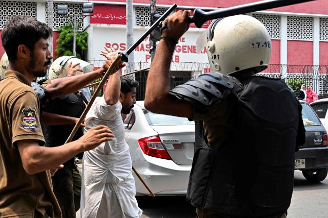 Police personnel detain a supporter of Pakistan Tehreek-e-Insaf (PTI) party during a protest demanding the release of their jailed leader and the country's former Prime Minister Imran Khan, in Lahore on August 5, 2026. (Photo by Arif ALI / AFP)
