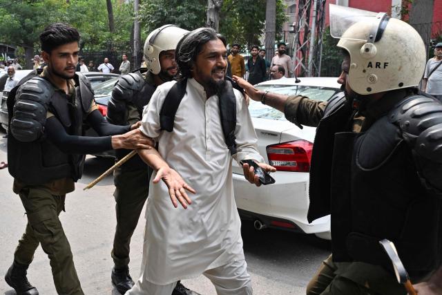 Police personnel detain a supporter of Pakistan Tehreek-e-Insaf (PTI) party during a protest demanding the release of their jailed leader and the country's former Prime Minister Imran Khan, in Lahore on August 5, 2026. (Photo by Arif ALI / AFP)