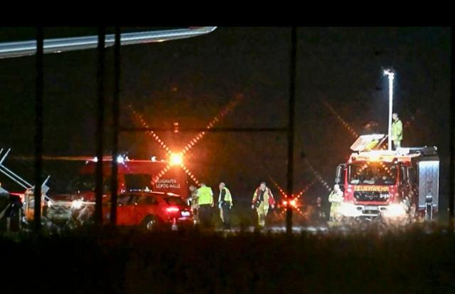 A video grab taken from a video footage by News5 from August 5, 2026 shows emergency services, police and firefighers deployed at German airport Leipzig-Halle in Schkeuditz, eastern Germany, after a drone was spotted nearby. German police deployed a bomb disposal robot at the airport after a drone was found near a Ukrainian-flagged cargo plane overnight, also forcing the diversion of numerous flights. Another aircraft, which had to abort its scheduled landing at Leipzig-Halle airport, then collided mid-air with an unknown object several kilometres away but later landed safely, the government said. The airport in eastern Germany plays a key role in the transport of military goods, including by the German military and NATO allies, and also serves as a base for Ukraine's Antonov Airlines. (Photo by NEWS5 / AFP)