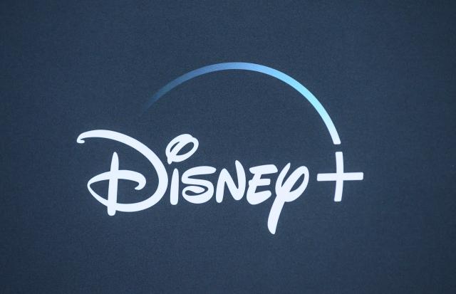 (FILES) The Disney+ logo is seen on the backdrop for the World Premiere of "The Mandalorian" at El Capitan theatre in Hollywood on November 13, 2019. The Walt Disney Co. said on August 5, 2026, that it had signed a deal with TikTok allowing users of the hugely popular video platform to add extracts of Disney films and characters in what it billed a "first-of-its-kind agreement". (Photo by Nick Agro / AFP)