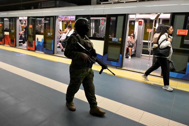 A soldier patrols a metro station in northern Quito on August 5, 2026. Ecuador deployed 4,000 police officers and military personnel in the capital to reinforce security amid rising violence and recent reports of disappearances. (Photo by Rodrigo BUENDIA / AFP)