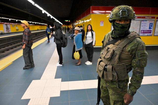 A soldier patrols a metro station in northern Quito on August 5, 2026. Ecuador deployed 4,000 police officers and military personnel in the capital to reinforce security amid rising violence and recent reports of disappearances. (Photo by Rodrigo BUENDIA / AFP)