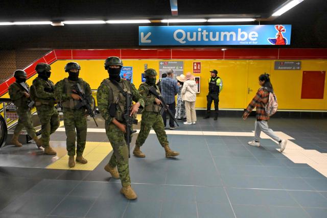 Soldiers patrol a metro station in northern Quito on August 5, 2026. Ecuador deployed 4,000 police officers and military personnel in the capital to reinforce security amid rising violence and recent reports of disappearances. (Photo by Rodrigo BUENDIA / AFP)