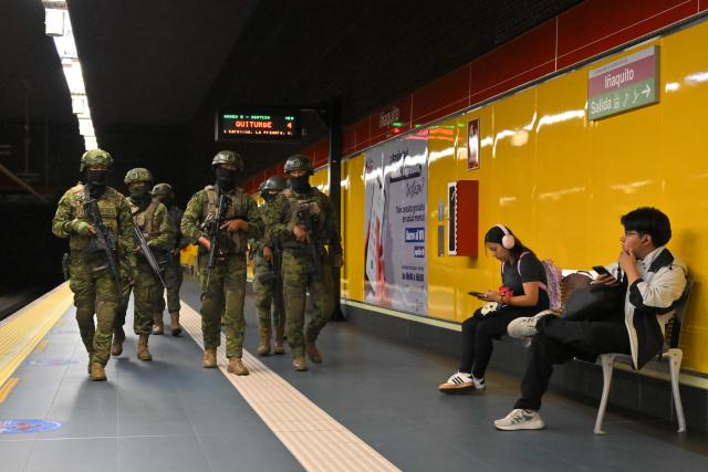 Soldiers patrol a metro station in northern Quito on August 5, 2026. Ecuador deployed 4,000 police officers and military personnel in the capital to reinforce security amid rising violence and recent reports of disappearances. (Photo by Rodrigo BUENDIA / AFP)