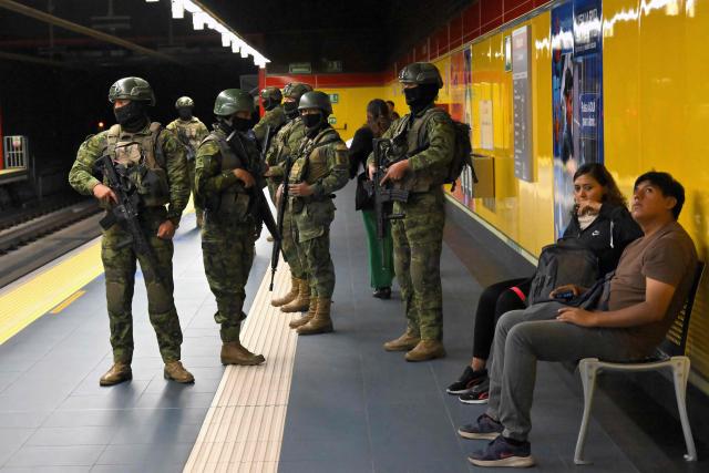 Soldiers patrol a metro station in northern Quito on August 5, 2026. Ecuador deployed 4,000 police officers and military personnel in the capital to reinforce security amid rising violence and recent reports of disappearances. (Photo by Rodrigo BUENDIA / AFP)