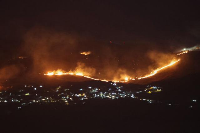 Forest fires sweep through the outskirts of the southern village of Kfar Shouba as a result of Israeli shelling that targeted the area, as seen from the southern Lebanese area of Marjayoun on August 5, 2026. Israel's military resumed strikes in southern Lebanon on August 5 despite ongoing talks, blaming a ceasefire violation by militant group Hezbollah as state media reported at least one person killed. (Photo by AFP) / 