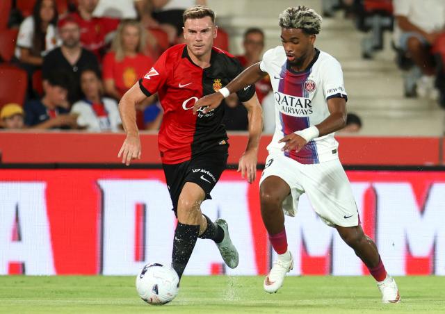 Real Mallorca's Spanish defender #03 Antonio Latorre (L) and Paris Saint-Germain's French forward #49 Ibrahim Mbaye fight for the ball during the Ciutat de Palma trophy friendly football match between Mallorca RCD and Paris Saint-Germain FC at Mallorca Son Moix Stadium in Palma de Mallorca on August 8, 2026. (Photo by JAIME REINA / AFP)