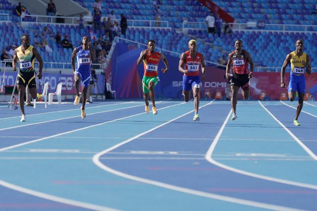 (L to R) Jamaica's Tyquendo Tracey, British Virgin Islands' Wanyae Belle, Grenada's Nazzio John, Dominican Republic's Alexander Ogando, Panama's Arturo Deliser and Barbados' Kuron Griffith compete in the men's 200m semifinal, heat 3, during the XXV Central American and Caribbean Games at the Felix Sanchez Olympic Stadium in Santo Domingo on August 5, 2026. (Photo by Francesco SPOTORNO / AFP)