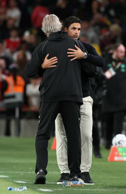Real Betis' Chilean coach Manuel Pellegrini (L) embraces Arsenal's Spanish manager Mikel Arteta at the final whistle during the friendly pre-season football match between Arsenal and Real Betis, at the Aviva Stadium in Dublin, Ireland on August 5, 2026.  (Photo by Paul Faith / AFP)