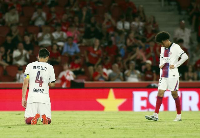 Paris Saint-Germain's Brazilian defender #04 Lucas Beraldo and Paris Saint-Germain's French midfielder #58 Rayan Abo El Nay react to their defeat at the end of the Ciutat de Palma trophy friendly football match between Mallorca RCD and Paris Saint-Germain FC at Mallorca Son Moix Stadium in Palma de Mallorca on August 8, 2026. (Photo by JAIME REINA / AFP)