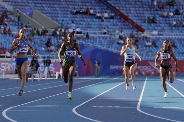 (L to R) British Virgin Islands' Beyonce Defreitas, Jamaica's Niesha Burgher, Guatemala's Mariandree Chacon and Trinidad and Tobago's Taejha Badal compete in the women's 200m semifinal, heat 3, during the XXV Central American and Caribbean Games at the Felix Sanchez Olympic Stadium in Santo Domingo on August 5, 2026. (Photo by Francesco SPOTORNO / AFP)