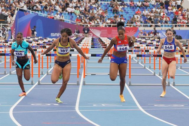 (L to R) Bahamas' Denisha Cartwright, Colombia's Maria Murillo, Cuba's Greisys Roble and Puerto Rico's Paola Vazquez compete in the women's 100m hurdles final during the XXV Central American and Caribbean Games at the Felix Sanchez Olympic Stadium in Santo Domingo on August 5, 2026. (Photo by Francesco SPOTORNO / AFP)